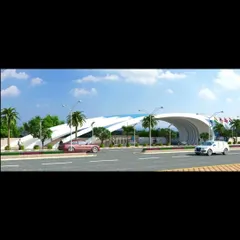 A daytime view of the township entrance gate, showing how it frames the entry road. The design is both functional and artistic, setting a premium tone for the entire community.