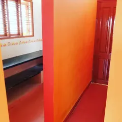 Another view of the colorful interior project in Kengeri. You can see how the bright wall contrasts with the other surfaces, making the whole area feel more dynamic. I can help you with color selection for your home.