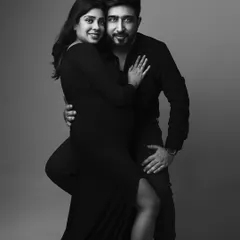 A glamorous and confident black and white maternity portrait. The couple's pose is both elegant and powerful, creating a timeless and classic piece of art.