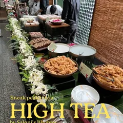 A sneak peek into a high-tea setup, perfect for festive card parties. The menu includes elegant bites like mini ricotta sandwiches and freshly baked banana walnut cake, creating a refined atmosphere.