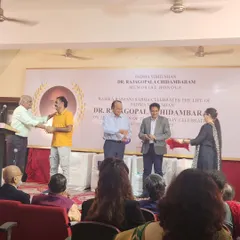 Shaking hands with the dignitaries on stage after being presented with the award.