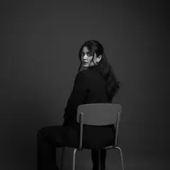 A black and white portrait that captures a moment of quiet intensity. As an advocate, listening and observing are as important as speaking.