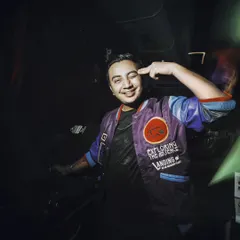 A playful moment interacting with the crowd. It's all about having fun and sharing good vibes from behind the DJ booth.
