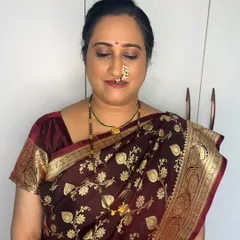 The makeup details for Kasturi's Mangalagaur look. The soft gold eyeshadow and defined brows enhance her features beautifully without feeling heavy.