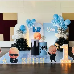 A cool and fun Boss Baby themed first birthday for Krish. This decoration features character cutouts, a light-up marquee number '1', and a sleek blue, black, and silver color scheme.