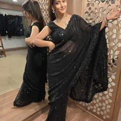 A glamorous black sequin saree, perfect for making a bold statement at any evening party.