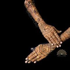 A striking back of hand design against a black background. The design features traditional symbols and intricate patterns, creating a bold and dramatic effect.
