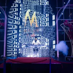 Here I am performing in front of a massive, floor-to-ceiling LED wall with custom geometric visuals. This is the core of my VDJ service, creating a stunning backdrop for any large event.