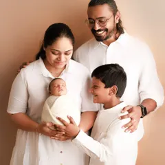 All smiles for the new arrival. It's so special to see a big brother looking at his new sibling with so much love and excitement. These are the moments that become treasured family memories.