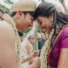 A close-up of a tender moment between the couple during their wedding ceremony, their smiles reflecting the joy of the occasion.