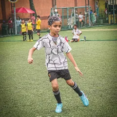 A player showing agility and balance on the pitch. Every movement is trained, every action is purposeful.