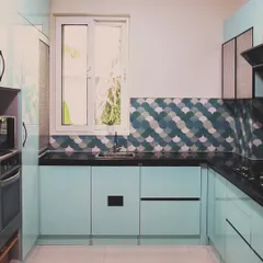A close-up of the sink area, highlighting the stunning fish-scale patterned backsplash in shades of blue, green, and white. This artistic detail serves as the focal point of the kitchen.