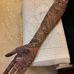 The full arm view, where you can see the 'R' initial clearly visible amongst the dense patterns. It's like a beautiful secret hidden in the art.