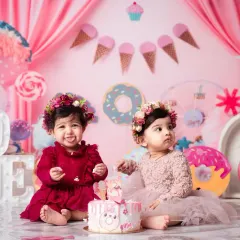 We go all out for first birthdays! This sweet duo is celebrating in our custom 'Candy Land' theme, one of the many imaginative worlds we can create for your child's special day.