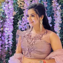 Another angle of this beautiful party makeup. The soft lighting highlights the radiant finish of her skin and the intricate details of her outfit.