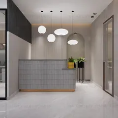 The reception area of the office, with a modern fluted desk, statement pendant lights, and an arched mirror to create a welcoming first impression.