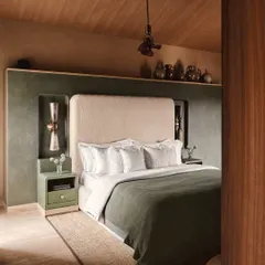 This bedroom at Embassy 821 is a sanctuary of calm, designed with a muted palette of olive green and beige. The custom headboard niche and artisanal side tables demonstrate our focus on integrated, intentional design.