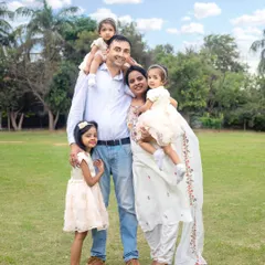 A bright and sunny outdoor family portrait. The natural setting allows for relaxed and genuine interactions, resulting in beautiful, candid memories.