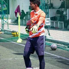A goalkeeper stands ready between the posts. Our facilities are fully equipped for official matches, including proper goalposts and well-marked playing areas.