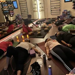 Participants resting deeply during a Naada Yoga session. I move through the space to ensure the healing sounds reach everyone, helping to balance the chakras and calm the nervous system.