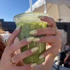 An aesthetic moment with my matcha latte and fresh chrome nails.