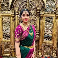 A beautiful portrait against an ornate gold backdrop. The makeup enhances her natural features, making her look elegant and festive.