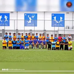 The team selected for our international training camp, standing together before a session. This is a group of dedicated players who earned their spot to train and compete in a professional European football environment.