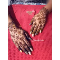 A classic mandala or "butti" design on the back of the hands for a baby shower celebration. It's simple, elegant, and timeless.