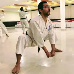 Stretching beyond your perceived limits will yield powerful results. This deep horse stance builds leg strength, stability, and mental endurance.
