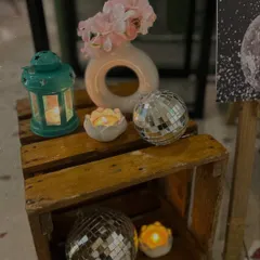 Small decorative corners add to the overall ambiance. Here, we used wooden crates, disco balls, and candles to create a rustic-glam vignette.