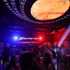 A wide shot of a packed club night. My visuals are a key part of the experience, creating an immersive atmosphere that complements the music.