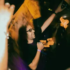 Caught in a moment of pure energy, hyping the crowd on the mic. This is what it's all about, feeding off the room's vibe and giving it right back.