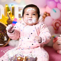 A close-up of Prisha enjoying her birthday cake, with frosting on her hands and face. These are the details you'll want to remember.