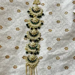 A Kundan hair choti with green Meenakari work and black bead drops. This rental accessory is designed to match my green bridal sets.
