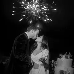 A magical moment as the couple kisses under a sky of fireworks. This perfectly timed black and white shot is the epitome of a fairytale wedding celebration.