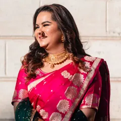 This client's happy, sunlit smile says it all. Her soft brown highlights add a gentle warmth that enhances her natural hair color and beautifully complements her traditional pink saree for the wedding ceremony.