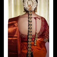 To complete a traditional bridal look, I offer exquisite hair accessories like this lightweight bridal jada. This piece, seen here adorning a classic bridal braid, features beautiful Lakshmi motifs and is designed to add a divine touch without feeling heavy.