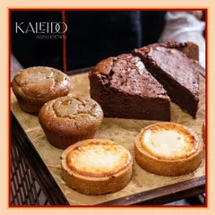 A platter of our assorted desserts, perfect for catering or a party. This selection includes our Japanese Cheese Tarts, muffins, and a rich chocolate cake.