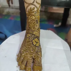 A close-up of a single foot adorned with a bold, floral-themed design. The shading gives the roses a beautiful, three-dimensional effect.