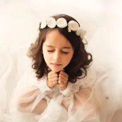 A serene and angelic portrait. Her closed eyes and peaceful expression create a truly beautiful and timeless image against a soft white background.