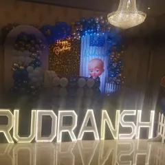 Another angle of the Boss Baby themed stage, showing how the balloon garlands and character cutouts frame the entire setup.