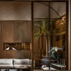 The partition system works in concert with other architectural elements, like the recessed wall niche. This demonstrates my holistic approach to ensuring all components of a space are in perfect harmony.