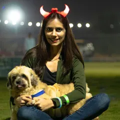 A pet parent in devil horns poses with her fluffy companion at our Halloween party. I encourage everyone, humans included, to get into the spooky spirit.