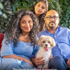 A beautiful family portrait where their small dog is comfortably at the center of it all. This is what a complete family looks like.