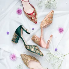 This flat lay composition showcases a collection of ethnic and bridal footwear. By arranging the colorful, embellished shoes on a soft white fabric with scattered flowers, I created a delicate and festive image that highlights intricate beadwork.