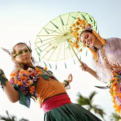 Performers in ethereal, nature inspired costumes with parasols greet guests and add to the festival like atmosphere of the poolside Haldi.