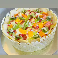 Our stunning Mixed Fruit Cake, loaded with fresh kiwi, apple, pomegranate, grapes, and mango, all held together by a delicate white chocolate lattice.