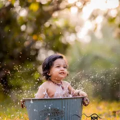 Another magical moment from a golden hour splash session. We love capturing the water droplets frozen in time as your little one plays.
