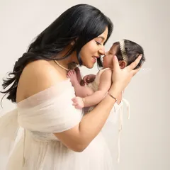A mother gently touches her nose to her baby's, a simple gesture filled with immense love. These are the intimate, unposed moments I strive to capture.
