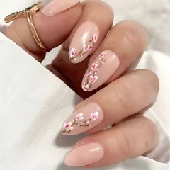 A beautiful spring-themed design featuring delicate, hand-painted cherry blossoms on a nude base. This is a perfect example of elegant and artistic floral nail art.